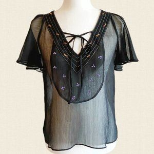 Sheer black blouse with flutter sleeves